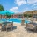 a pool with chairs and umbrellas